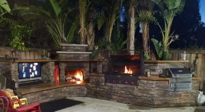 Outdoor kitchen with fireplace and Memphis Grill