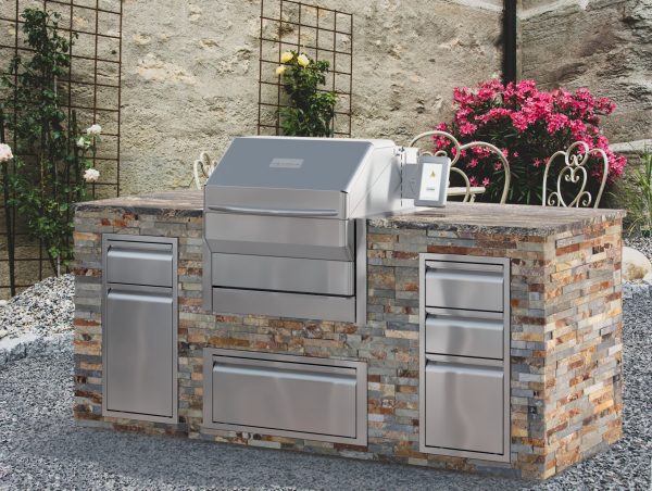 Memphis pro built in wood fire grill in outdoor kitchen in a garden